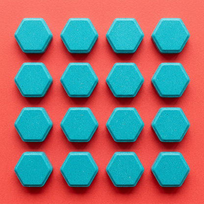 Overhead flat lay coral background 12 tablets grid